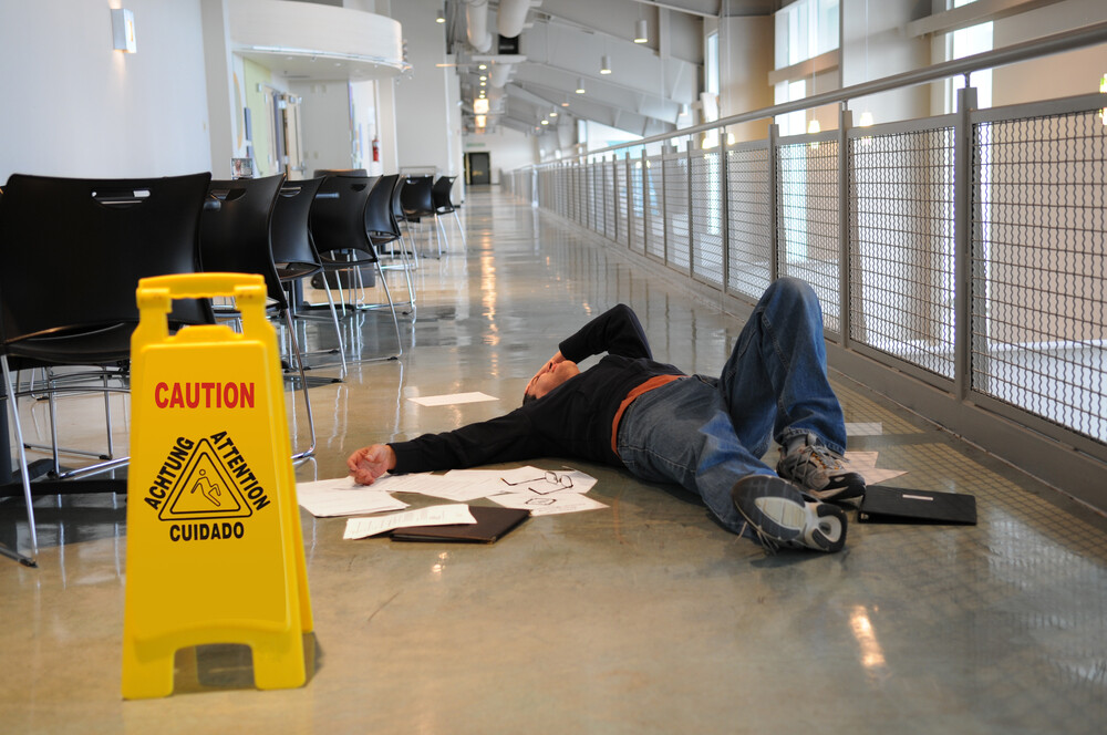 Man Slips on Flooring Despite Caution Sign