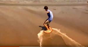 Skimboarder showing hydropaning on slip resistant surface