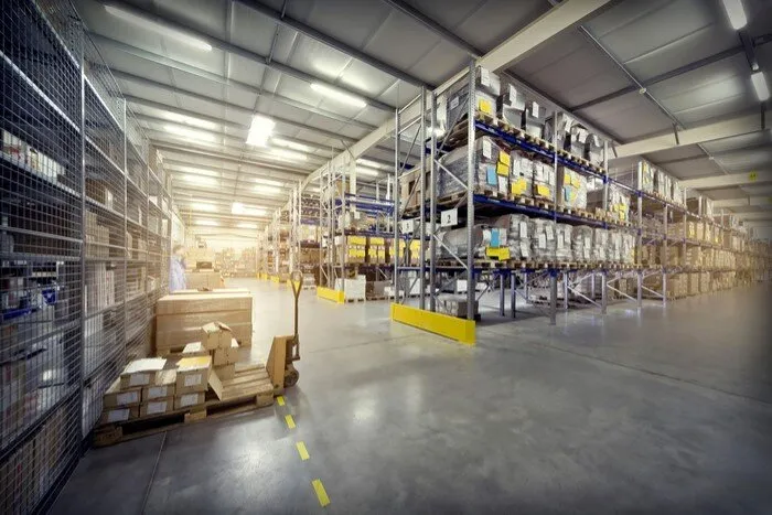 well-lit warehouse with high ceilings and metal shelving units