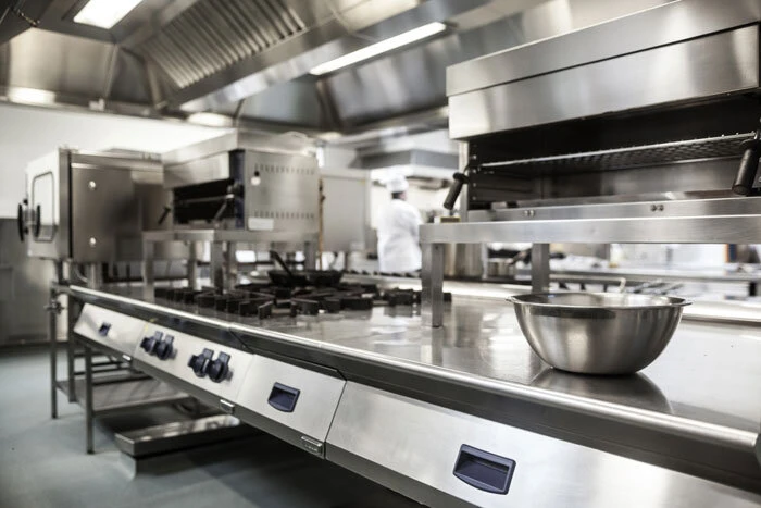 a modern commercial kitchen with stainless steel appliances