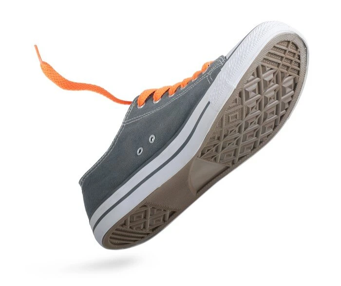 gray sneaker with orange laces
