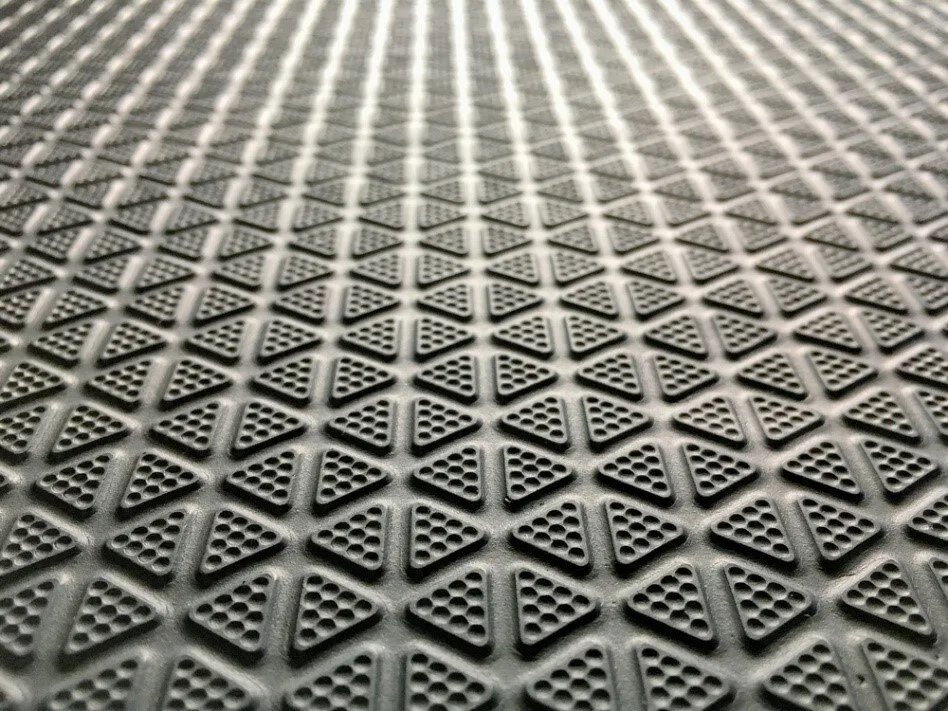 black anti-slip mat with small, textured triangles