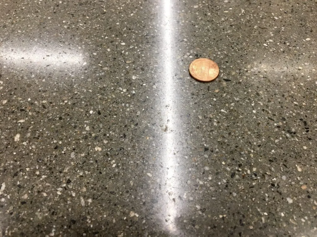 polished concrete floor with a penny
